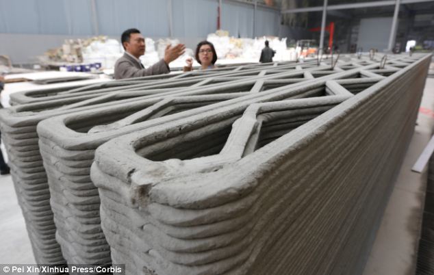 Hi-tech walls: Chinese firm Win Sun piped a mixture of cement and construction waste to build up walls layer by layer (pictured) in a speedy construction process that could transform the way affordable homes are built