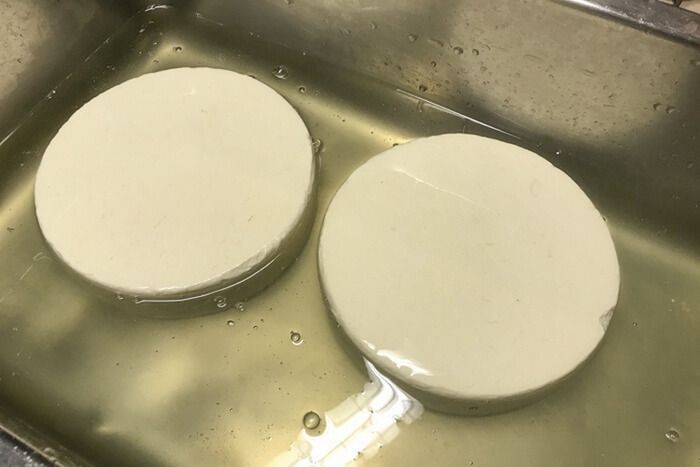 Полоска сыра в ванночке с соляным раствором.